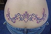 Sexy_Lower_back_tattoo_Girl_tattoo_Girly_flower[1].jpg